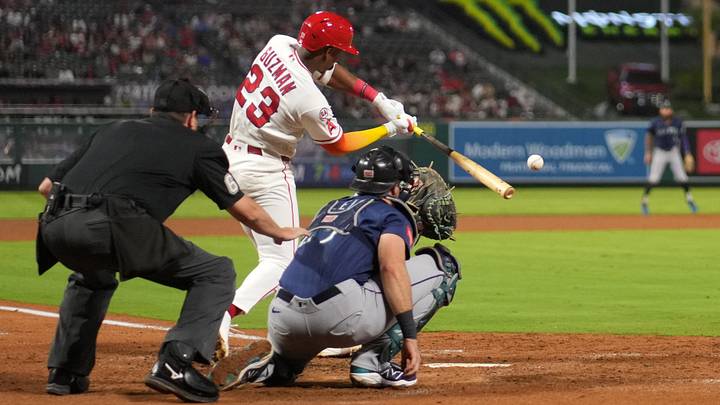 Sep 14, 2026; Anaheim, California, USA; Los Angeles Angels third baseman Denzer Guzman (23) hits a two-run single Sep 14, 2026; Anaheim, California, USA; Los Angeles Angels third baseman Denzer Guzman (23) hits a two-run single
