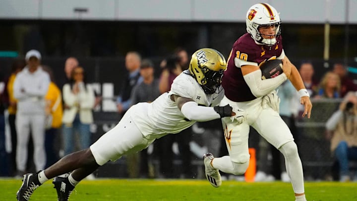 UCF defensive end Malachi Lawrence (51) tackles ASU quarterback Sam Leavitt (10) as he scrambles during a game at Mountain America Stadium in Tempe on Nov. 9, 2024.