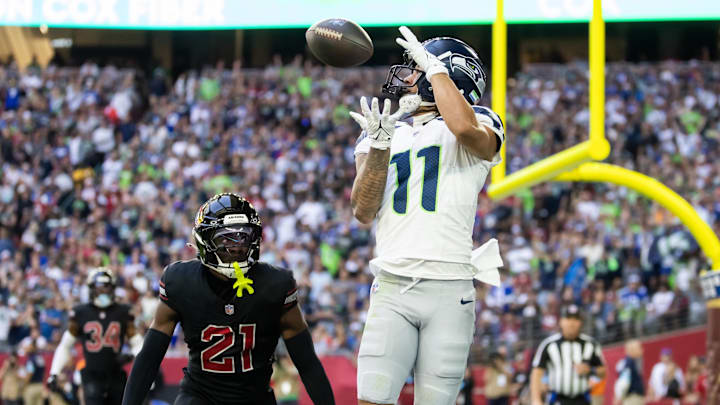 Dec 8, 2024; Glendale, Arizona, USA; Seattle Seahawks wide receiver Jaxon Smith-Njigba (11) catches a touchdown pass against Arizona Cardinals cornerback Garrett Williams (21) in the first half at State Farm Stadium. Mandatory Credit: Mark J. Rebilas-Imagn Images Dec 8, 2024; Glendale, Arizona, USA; Seattle Seahawks wide receiver Jaxon Smith-Njigba (11) catches a touchdown pass against Arizona Cardinals cornerback Garrett Williams (21) in the first half at State Farm Stadium. Mandatory Credit: Mark J. Rebilas-Imagn Images