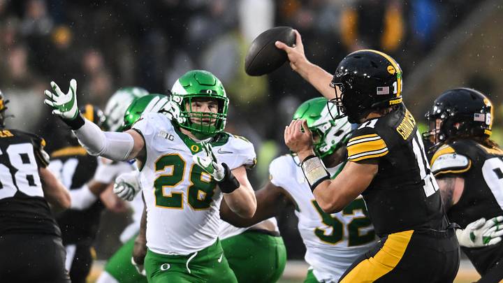 Nov 8, 2025; Iowa City, Iowa, USA; Oregon Ducks linebacker Bryce Boettcher (28) pressures Iowa Hawkeyes quarterback Mark Gronowski (11) during the second quarter at Kinnick Stadium. Mandatory Credit: Jeffrey Becker-Imagn Images