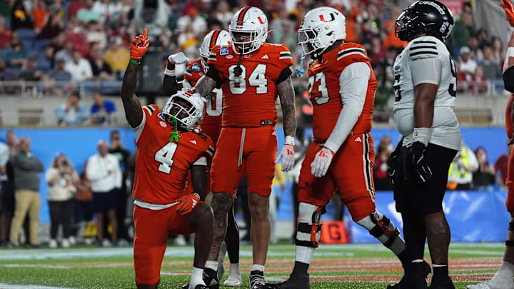 Dec 28, 2024; Orlando, FL, USA; Miami Hurricanes running back Mark Fletcher Jr. (4) celebrates after scoring a touchdown against the Iowa State Cyclones during the second half at Camping World Stadium. Mandatory Credit: Jasen Vinlove-Imagn Images