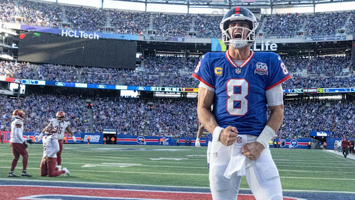 Nov 3, 2024; East Rutherford, New Jersey, USA; New York Giants quarterback Daniel Jones (8) celebrates after scoring a 2nd half touchdown against the Washington Commanders at MetLife Stadium. Mandatory Credit: Robert Deutsch-Imagn Images