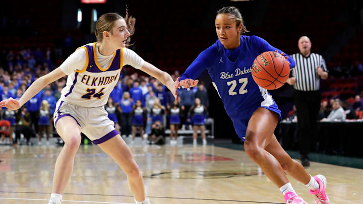 Whitefish Bay High School's Sage Miskel (22) drives to the basket past Elkhorn Makenna Guth (24) during a WIAA Division 2 state semifinal on March 13, 2026. Whitefish Bay High School's Sage Miskel (22) drives to the basket past Elkhorn Makenna Guth (24) during a WIAA Division 2 state semifinal on March 13, 2026.
