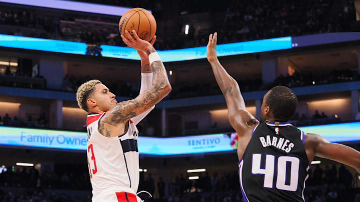 Dec 18, 2023; Sacramento, California, USA; Washington Wizards forward Kyle Kuzma (33) scores a basket against Sacramento Kings forward Harrison Barnes (40) during the third quarter at Golden 1 Center. Mandatory Credit: Kelley L Cox-USA TODAY Sports