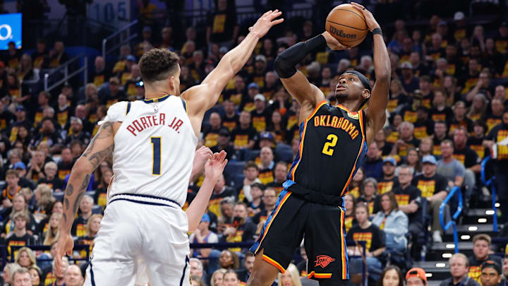 May 5, 2025; Oklahoma City, Oklahoma, USA; Oklahoma City Thunder guard Shai Gilgeous-Alexander (2) shoots as Denver Nuggets forward Michael Porter Jr. (1) defends during the second half during game one of the second round for the 2025 NBA Playoffs at Paycom Center. Mandatory Credit: Alonzo Adams-Imagn Images