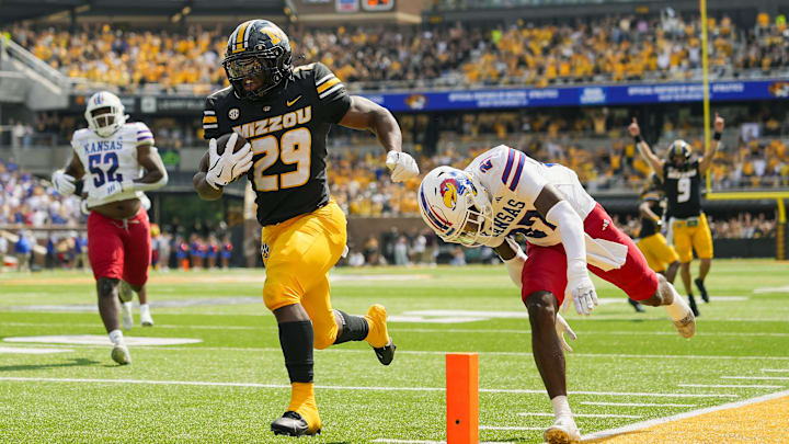 Sep 6, 2025; Columbia, Missouri, USA; Missouri Tigers running back Ahmad Hardy (29) runs for a touchdown against Kansas Jayhawks safety Taylor Davis (27) during the first half at Faurot Field at Memorial Stadium. Mandatory Credit: Jay Biggerstaff-Imagn Images