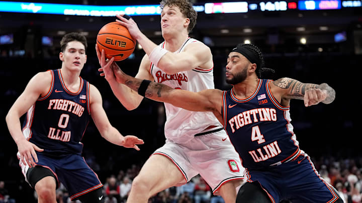 Ohio State Buckeyes center Christoph Tilly (13) muscles past Illinois Fighting Illini guard Kylan Boswell (4) and forward David Mirkovic (0) during the first half of the NCAA men's basketball game in Columbus on Dec. 9, 2025. Ohio State Buckeyes center Christoph Tilly (13) muscles past Illinois Fighting Illini guard Kylan Boswell (4) and forward David Mirkovic (0) during the first half of the NCAA men's basketball game in Columbus on Dec. 9, 2025.