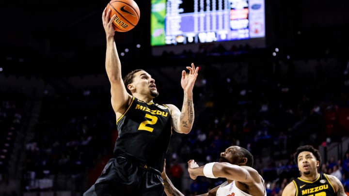 Jan 14, 2023; Gainesville, Florida, USA; Missouri Tigers guard Tre Gomillion (2) makes a layup over Florida Gators guard Kyle Lofton (11) during the first half at Exactech Arena at the Stephen C. O'Connell Center. Mandatory Credit: Matt Pendleton-USA TODAY Sports