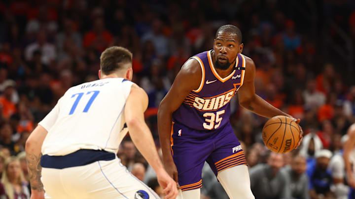 Oct 26, 2024; Phoenix, Arizona, USA; Phoenix Suns forward Kevin Durant (35) moves the ball against Dallas Mavericks guard Luka Doncic (77) in the first half of the home opener at Footprint Center. Mandatory Credit: Mark J. Rebilas-Imagn Images Oct 26, 2024; Phoenix, Arizona, USA; Phoenix Suns forward Kevin Durant (35) moves the ball against Dallas Mavericks guard Luka Doncic (77) in the first half of the home opener at Footprint Center. Mandatory Credit: Mark J. Rebilas-Imagn Images