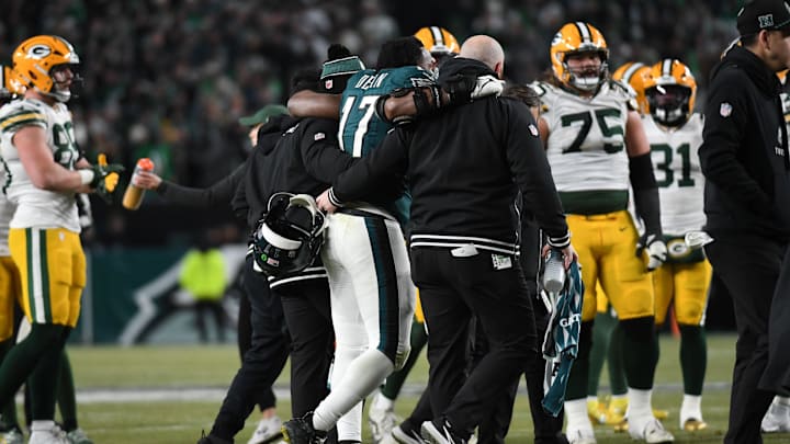 Jan 12, 2025; Philadelphia, Pennsylvania, USA; Philadelphia Eagles linebacker Nakobe Dean (17) is helped off the field against the Green Bay Packers during the first half in an NFC wild card game at Lincoln Financial Field. 