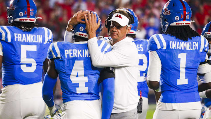 Nov 15, 2025; Oxford, Mississippi, USA; Mississippi Rebels head coach Lane Kiffin embraces linebacker Suntarine Perkins (4) during the second half against the Florida Gators at Vaught-Hemingway Stadium. Mandatory Credit: Petre Thomas-Imagn Images