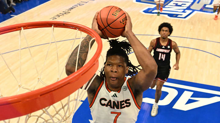 Mar 12, 2026; Charlotte, NC, USA; Miami (FL) Hurricanes forward Shelton Henderson (7) scores as Louisville Cardinals guard Adrian Wooley (14) defends in the second half at Spectrum Center. Mandatory Credit: Bob Donnan-Imagn Images Mar 12, 2026; Charlotte, NC, USA; Miami (FL) Hurricanes forward Shelton Henderson (7) scores as Louisville Cardinals guard Adrian Wooley (14) defends in the second half at Spectrum Center. Mandatory Credit: Bob Donnan-Imagn Images