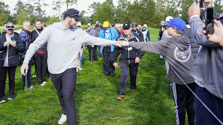 Feb 1, 2024; Pebble Beach, California, USA; Buffalo Bills quarterback Josh Allen (left) fist bumps a fan on the 10th hole during the first round of the ATT Pebble Beach Pro-Am golf tournament at Spyglass Hill Golf Course