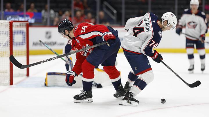 Sep 27, 2024; Washington, District of Columbia, USA; Washington Capitals Henrik Rybinski (58) and Columbus Blue Jackets defenseman Corson Ceulemans (74) battle for the puck in the third period at Capital One Arena. Mandatory Credit: Geoff Burke-Imagn Images