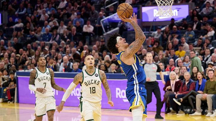 Jan 7, 2026; San Francisco, California, USA; Golden State Warriors forward Gui Santos (15) shoots the ball against Milwaukee Bucks forward Kyle Kuzma (18) and guard Kevin Porter Jr. (7) during the fourth quarter at Chase Center. Mandatory Credit: Robert Edwards-Imagn Images