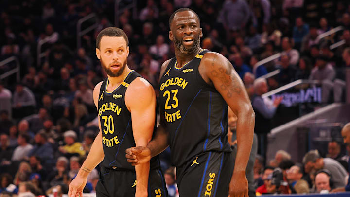 Feb 3, 2025; San Francisco, California, USA; Golden State Warriors guard Stephen Curry (30) and forward Draymond Green (23) look towards an Orlando Magic player at half time at Chase Center. Mandatory Credit: Kelley L Cox-Imagn Images