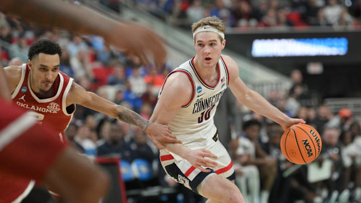 Mar 21, 2025; Raleigh, NC, USA;  Connecticut Huskies forward Liam McNeeley (30) controls the ball against the Oklahoma Sooners at Lenovo Center. Mandatory Credit: Zachary Taft-Imagn Images