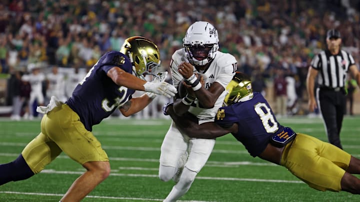 Sep 13, 2025; South Bend, Indiana, USA; Texas A&M Aggies quarterback Marcel Reed (10) runs the ball as Notre Dame Fighting Irish safety Adon Shuler (8) goes for a tackle during the second half at Notre Dame Stadium. Mandatory Credit: Trevor Ruszkowski-Imagn Images