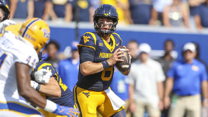 Sep 13, 2025; Morgantown, West Virginia, USA; West Virginia Mountaineers quarterback Nicco Marchiol (8) drops back to pass during the first quarter against the Pittsburgh Panthers at Milan Puskar Stadium. Mandatory Credit: Ben Queen-Imagn Images