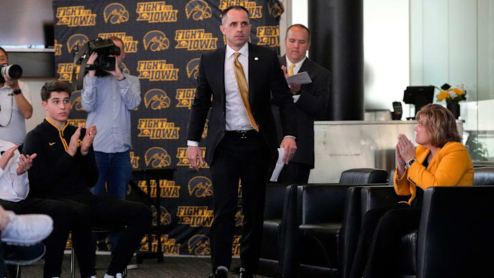 Ben McCollum, Iowa's new head men's basketball coach, walks to the podium during his introductory press conference Tuesday, March 25, 2025 at Carver-Hawkeye Arena in Iowa City, Iowa.