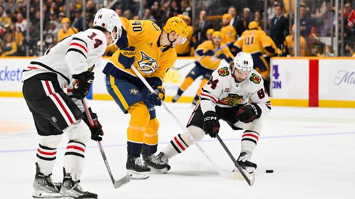 Jan 10, 2026; Nashville, Tennessee, USA;  Nashville Predators center Fedor Svechkiv (40) skates between Chicago Blackhawks defenseman Kevin Korchinski (14) and left wing Landon Slaggert (84) during the third period at Bridgestone Arena. Mandatory Credit: Steve Roberts-Imagn Images