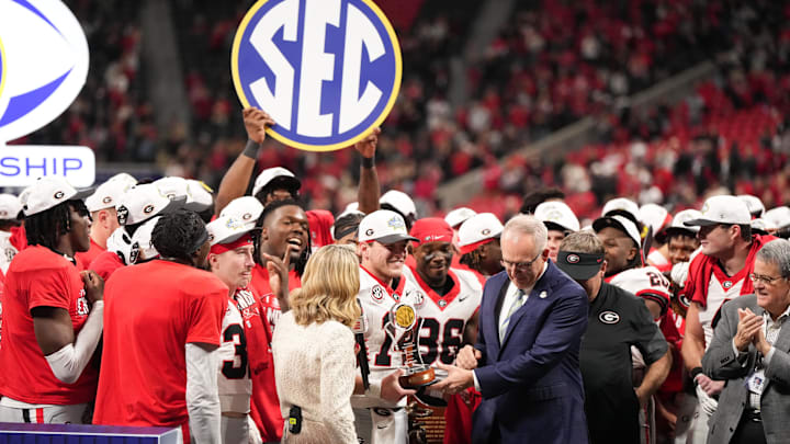 Dec 6, 2025; Atlanta, GA, USA; Georgia Bulldogs quarterback Gunner Stockton (14) is presented with the MVP trophy after the game against the Alabama Crimson Tide during the 2025 SEC Championship game at Mercedes-Benz Stadium. Mandatory Credit: Dale Zanine-Imagn Images Dec 6, 2025; Atlanta, GA, USA; Georgia Bulldogs quarterback Gunner Stockton (14) is presented with the MVP trophy after the game against the Alabama Crimson Tide during the 2025 SEC Championship game at Mercedes-Benz Stadium. Mandatory Credit: Dale Zanine-Imagn Images