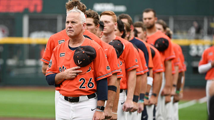 Jun 16, 2023; Omaha, NE, USA;  Virginia Cavaliers head coach Brian O'Connor stands for the national anthem before the game against the Florida Gators at Charles Schwab Field Omaha. Mandatory Credit: Steven Branscombe-Imagn Images