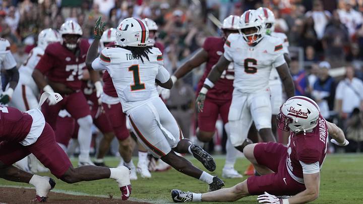 Sep 4, 2026; Stanford, California, USA;  Miami Hurricanes wide receiver Malachi Toney (1) scores a touchdown against the Stanford Cardinal during the first quarter at Stanford Stadium.  Mandatory Credit: Stan Szeto-Imagn Images