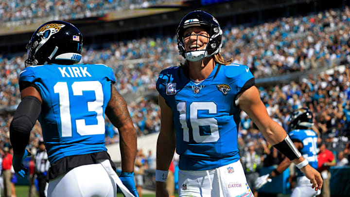 Jacksonville Jaguars quarterback Trevor Lawrence (16) celebrates his pass for a touchdown score. 