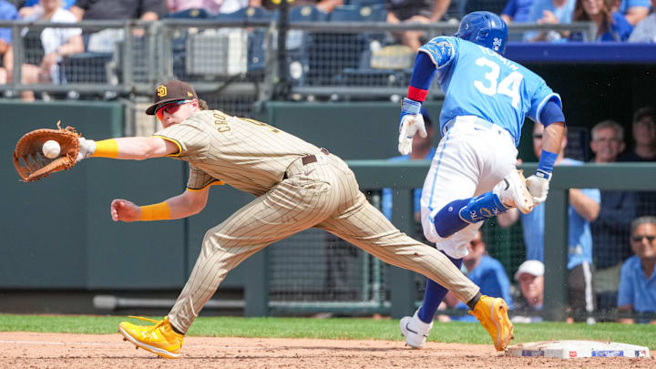 Jun 2, 2024; Kansas City, Missouri, USA; San Diego Padres Jake Cronenworth can’t make the tag as Kansas City Royals catcher Freddy Fermin (34) singles on a bunt in the eighth inning at Kauffman Stadium. Mandatory Credit: Denny Medley-USA TODAY Sports