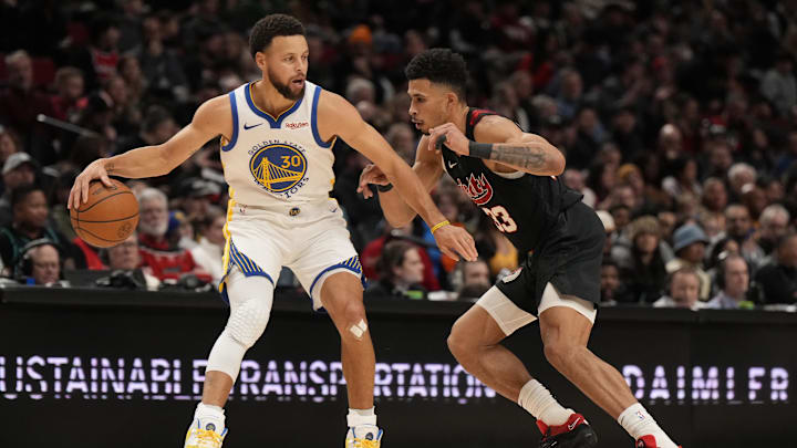 Golden State Warriors point guard Stephen Curry (30) controls the ball as Portland Trail Blazers forward Toumani Camara (33) defends during the second half at Moda Center. Mandatory Credit: Soobum Im-Imagn Images