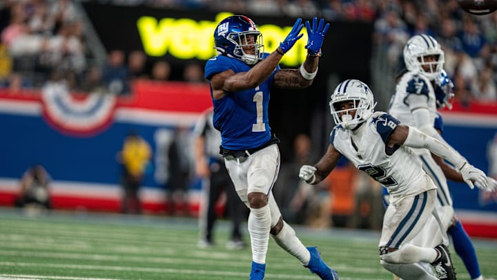 Sep 26, 2024; East Rutherford, NJ, US; New York Giants wide receiver Malik Nabers (1) catches a pass in the fourth quarter before being tackled by Dallas Cowboys cornerback Jourdan Lewis (2) at MetLife Stadium.  