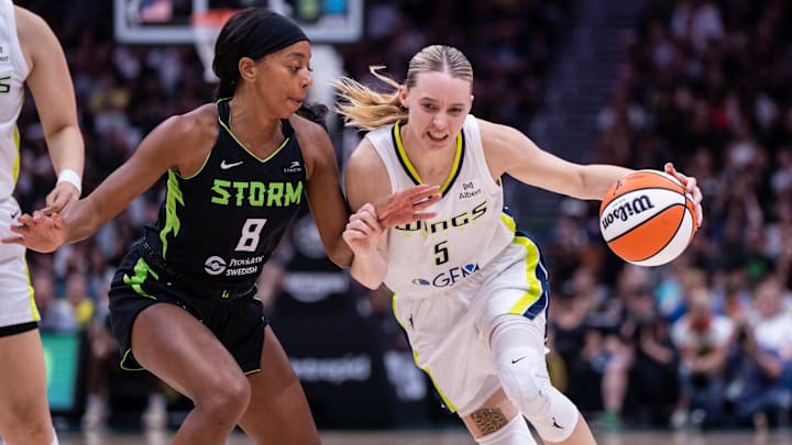 Jul 22, 2025; Seattle, Washington, USA;  Dallas Wings guard Paige Bueckers (5) dribbles the ball against Seattle Storm guard Lexie Brown (8) during the second half at Climate Pledge Arena. Mandatory Credit: Stephen Brashear-Imagn Images