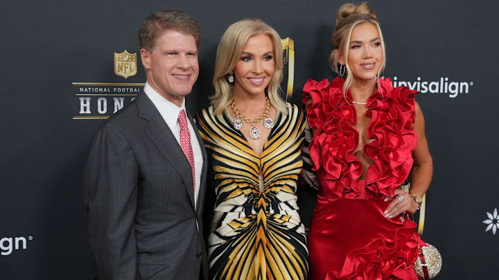 Kansas City Chiefs owner Clark Hunt (left) with his wife Tavia Shackles (center) and daughter Gracie Hunt (right)  on the red carpet before Super Bowl LIX NFL Honors.