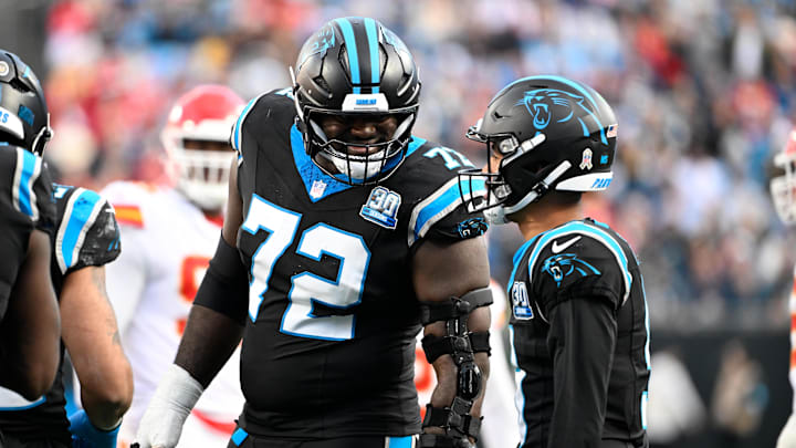 Nov 24, 2024; Charlotte, North Carolina, USA; Carolina Panthers offensive tackle Taylor Moton (72) with Carolina Panthers quarterback Bryce Young (9) in the fourth quarter at Bank of America Stadium. Mandatory Credit: Bob Donnan-Imagn Images