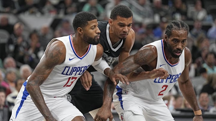 Nov 22, 2023; San Antonio, Texas, USA; Los Angeles Clippers forwards Paul George (13) and Kawhi Leonard (2) box out San Antonio Spurs forward Victor Wembanyama (1) during the second half at Frost Bank Center. Mandatory Credit: Scott Wachter-Imagn Images