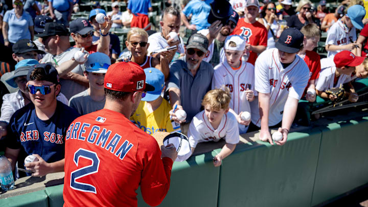 Feb 23, 2025; Fort Myers, Florida, USA; Boston Red Sox infielder Alex Bregman (2) signs autographs for fans before the start of their game against the Toronto Blue Jays at JetBlue Park at Fenway South. Mandatory Credit: Chris Tilley-Imagn Images