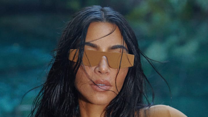 Kim Kardashian was photographed by Greg Swales in the Dominican Republic. Swimsuit by SKIMS. Sunglasses by Hall of Frames.