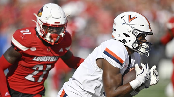 Oct 4, 2025; Louisville, Kentucky, USA; Virginia Cavaliers wide receiver Cam Ross (6) catches a pass against Louisville Cardinals defensive back D'Angelo Hutchinson (21) during the second quarter at L&N Federal Credit Union Stadium. Mandatory Credit: Jamie Rhodes-Imagn Images