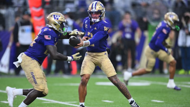 Nov 15, 2025; Seattle, Washington, USA; Washington Huskies quarterback Demond Williams Jr. (2) hands the ball off to running back Adam Mohammed (24) during the first half against the Purdue Boilermakers at Husky Stadium. Mandatory Credit: Steven Bisig-Imagn Images Nov 15, 2025; Seattle, Washington, USA; Washington Huskies quarterback Demond Williams Jr. (2) hands the ball off to running back Adam Mohammed (24) during the first half against the Purdue Boilermakers at Husky Stadium. Mandatory Credit: Steven Bisig-Imagn Images