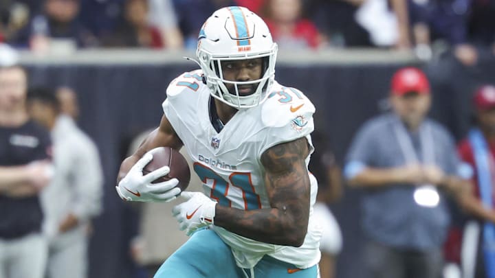 Dec 15, 2024; Houston, Texas, USA; Miami Dolphins running back Raheem Mostert (31) runs with the ball during the game against the Houston Texans at NRG Stadium. Mandatory Credit: Troy Taormina-Imagn Images