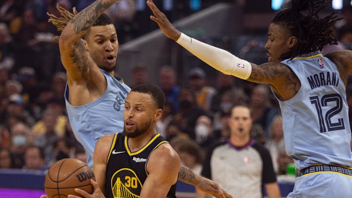 Golden State Warriors guard Stephen Curry (30) drives between Memphis Grizzlies forward Brandon Clarke (15) and guard Ja Morant (12) during the first half of game three of the second round for the 2022 NBA playoffs at Chase Center. Mandatory Credit: D. Ross Cameron-Imagn Images