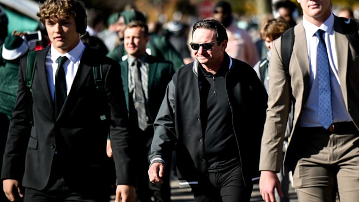 Michigan State's head coach Jonathan Smith, center, walks with the team to Spartan Stadium before the game against Indiana on Saturday, Nov. 2, 2024, in East Lansing.