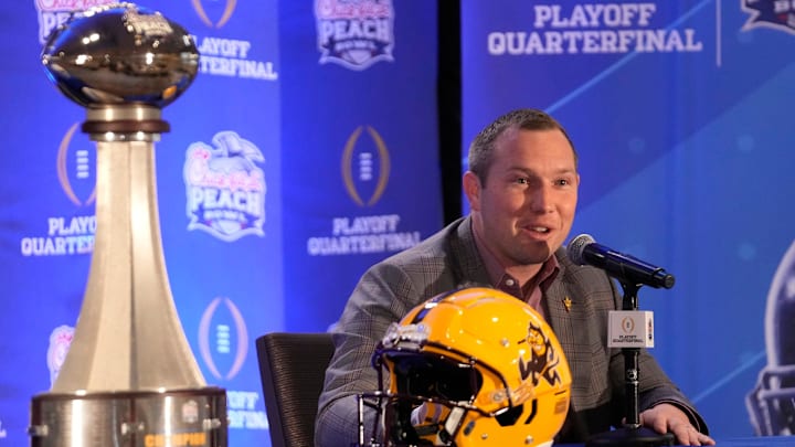 Arizona State head coach Kenny Dillingham responds to a question during a joint news conference with Texas head coach Steve Sarkisian before facing off in the Chick-fil-A Peach Bowl.