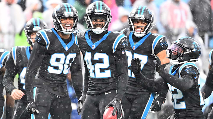 Carolina Panthers special teams players Amare Barno (90), Sam Franklin Jr. (42), Alex Cook (27), and Jammie Robinson (22) react in the first quarter at Bank of America Stadium.