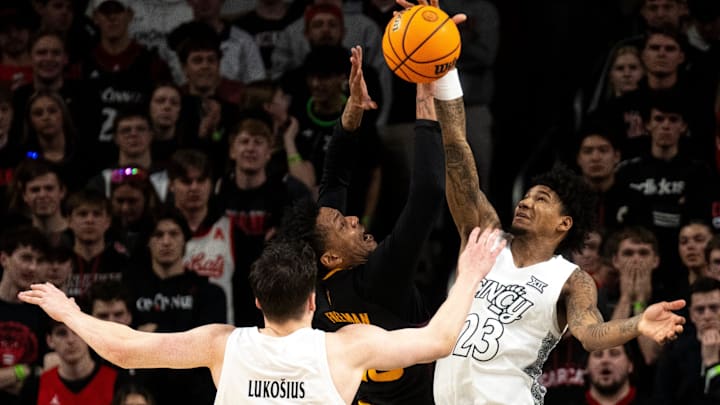 Cincinnati Bearcats forward Dillon Mitchell (23) blocks Arizona State Sun Devils guard/forward BJ Freeman (10) in the first half of the NCAA basketball game at Fifth Third Arena in Cincinnati on Saturday, January 18, 2025.