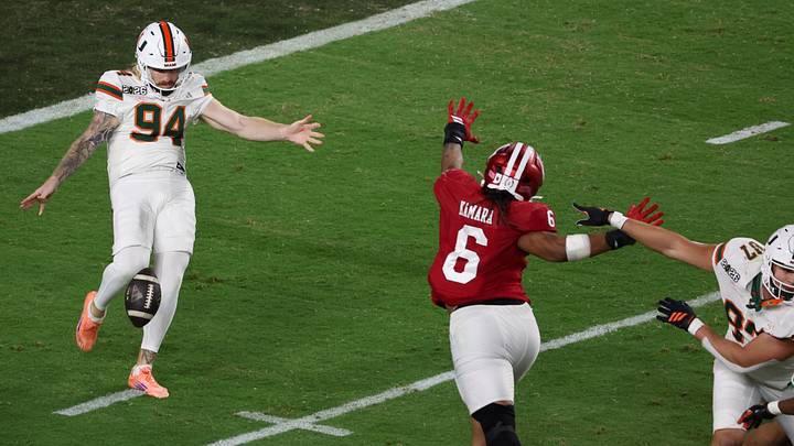 Jan 19, 2026; Miami Gardens, FL, USA; Indiana Hoosiers defensive lineman Mikail Kamara (6) blocks a punt by Miami Hurricanes punter Dylan Joyce (94) in the third quarter during the College Football Playoff National Championship game at Hard Rock Stadium. Mandatory Credit: Kim Klement Neitzel-Imagn Images