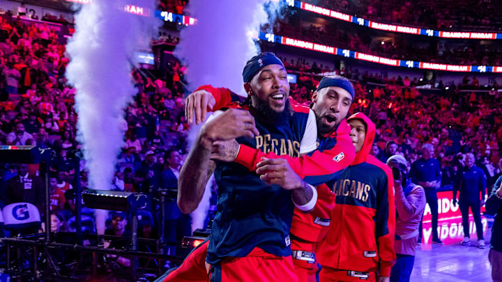 Oct 23, 2024; New Orleans, Louisiana, USA;  New Orleans Pelicans guard Jose Alvarado (15) jumps on forward Brandon Ingram (14) as he is announced to the fans to start the game against the Chicago Bulls at Smoothie King Center. 