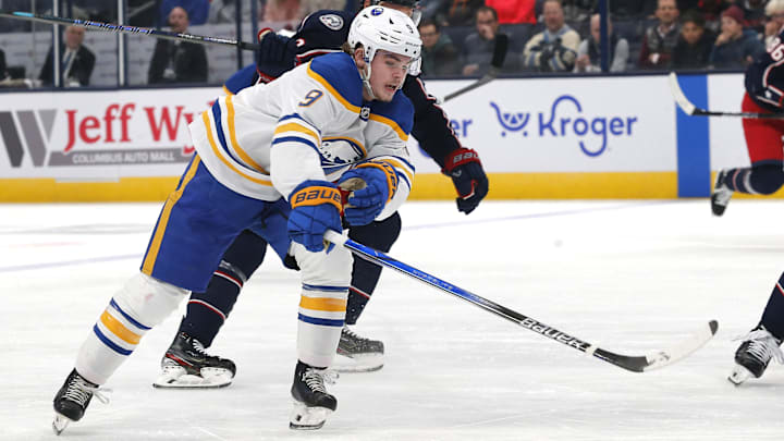Oct 17, 2024; Columbus, Ohio, USA; Buffalo Sabres left wing  Zach Benson (9) reaches after a loose puck as Columbus Blue Jackets defenseman Jack Johnson (3) defends during the first period at Nationwide Arena. Mandatory Credit: Russell LaBounty-Imagn Images