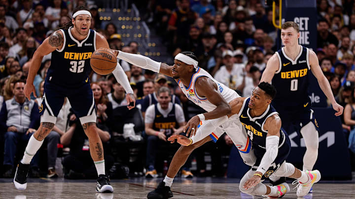 Oklahoma City Thunder guard Shai Gilgeous-Alexander (2) and Denver Nuggets guard Russell Westbrook (4) dive for a loose ball as forward Aaron Gordon (32) and guard Christian Braun (0) look on in the fourth quarter during game four of the second round of the 2025 NBA Playoffs at Ball Arena. Mandatory Credit: Isaiah J. Downing-Imagn Images
